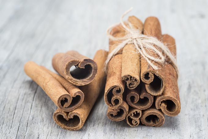 bigstock-Cinnamon-Sticks-On-A-Wooden-Ba-49719929_mini