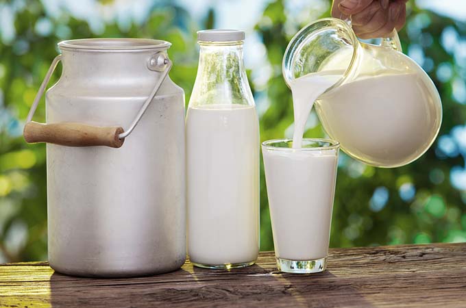 bigstock-Pouring-milk-in-the-glass-on-t-46131970