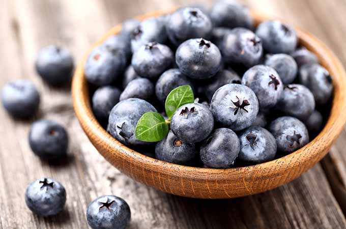 bigstock-Ripe-blueberry-in-a-wooden-pla-44027494