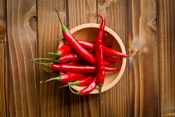 bigstock-top-view-of-chili-peppers-in-b-51670738_mini