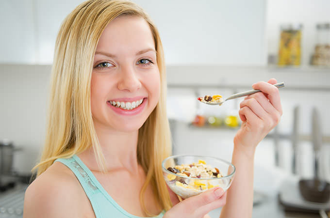 bigstock-Happy-Young-Woman-Eating-Healt-60323252