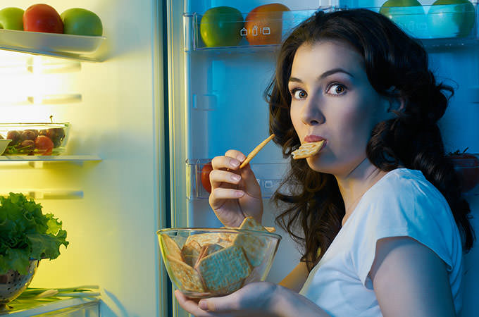 bigstock-a-hungry-girl-opens-the-fridge-36532972