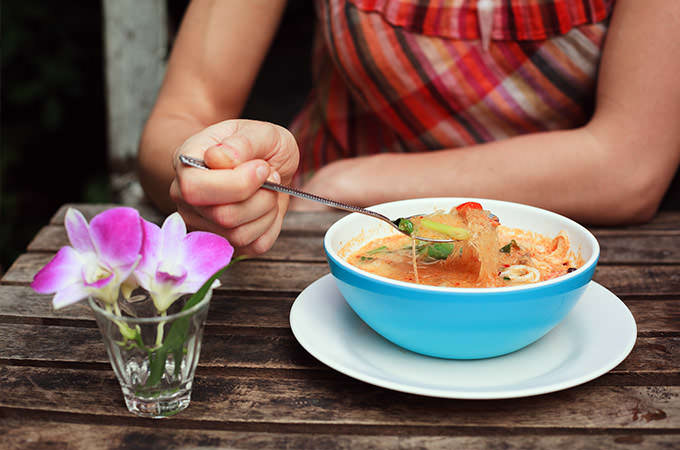 bigstock-Woman-Eating-Tom-Yum-Soup-81362696