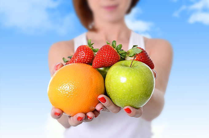 bigstock-Woman-Showing-Apple-Orange-Fr-86444738