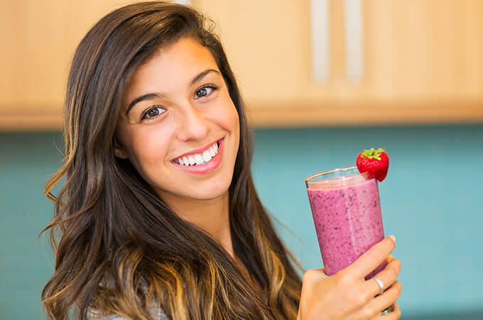 bigstock-Woman-Drinking-Fresh-Fruit-Smo-51850249