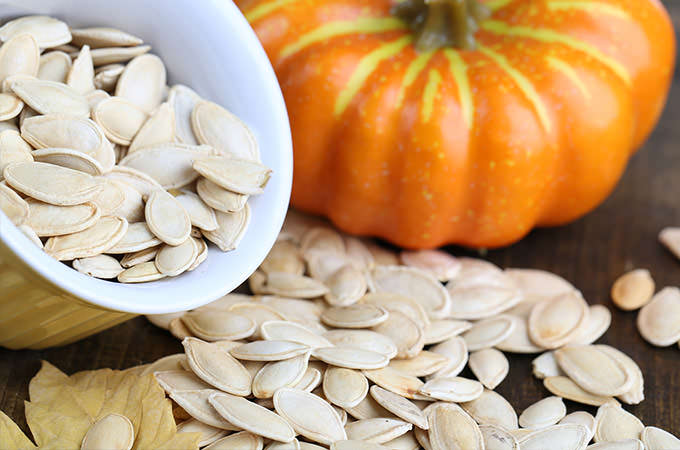 bigstock-Pumpkin-seeds-in-bowl-with-pum-56341094