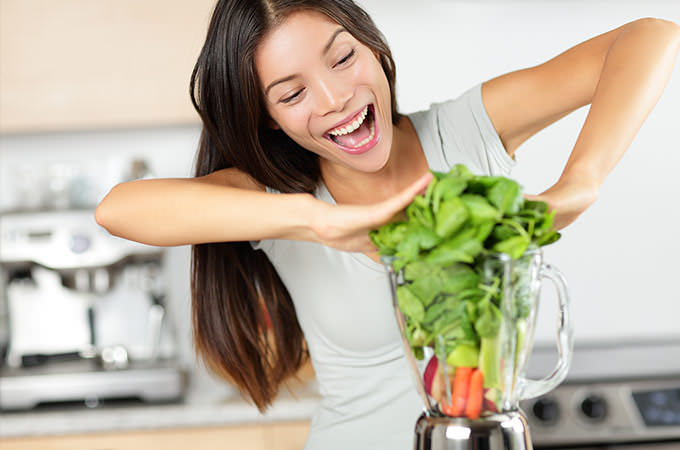 bigstock-Vegetable-smoothie-woman-makin-74368420