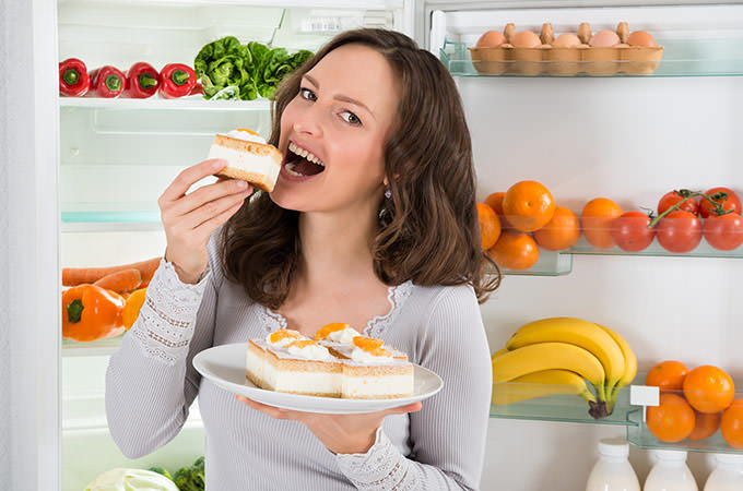 bigstock-Woman-Eating-Slice-Of-Cake-97331957