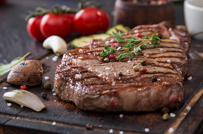 bigstock-Beef-rump-steak-on-black-stone-87727904