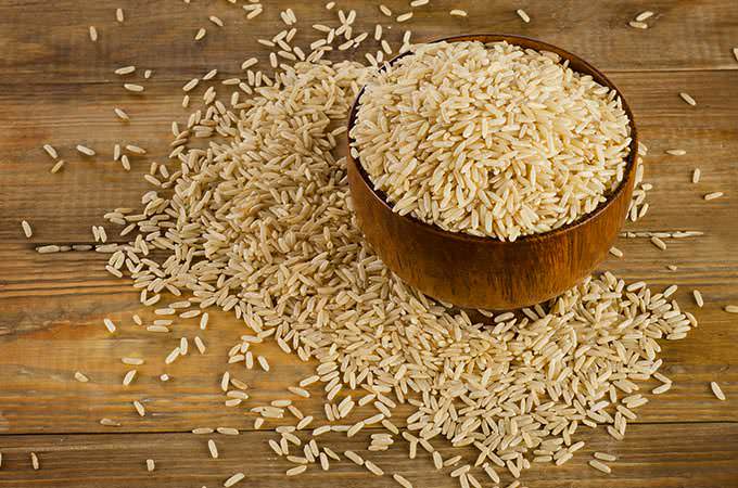 bigstock-Uncooked-Brown-Rice-In-A-Woode-90986588