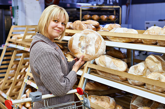 bigstock-Young-Woman-With-Bread-In-Supe-82606781