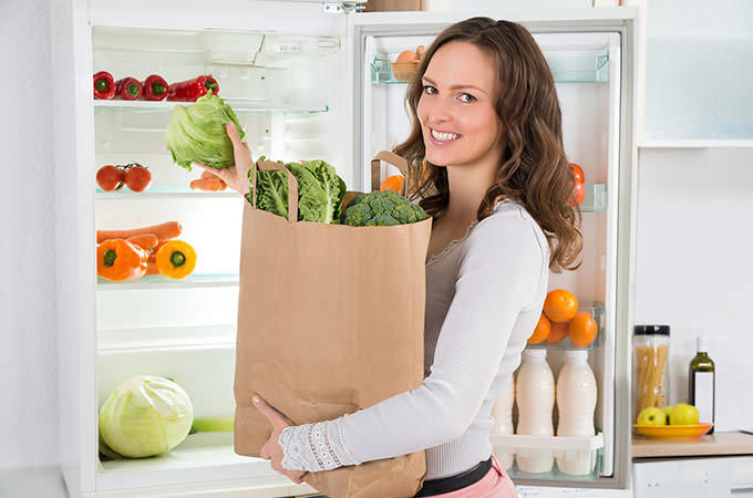 bigstock-Woman-Holding-Shopping-Bag-Wit-98663576