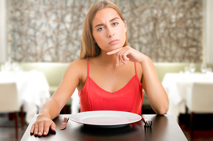 bigstock-Hungy-Woman-Waiting-With-An-Em-85457732