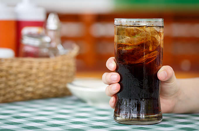 bigstock-Hand-Holding-Glass-Of-Cola-Dri-74939704